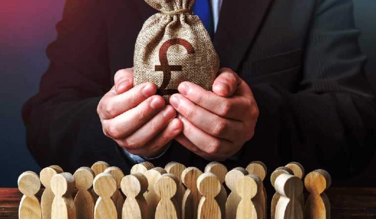A man holding a bag of coins