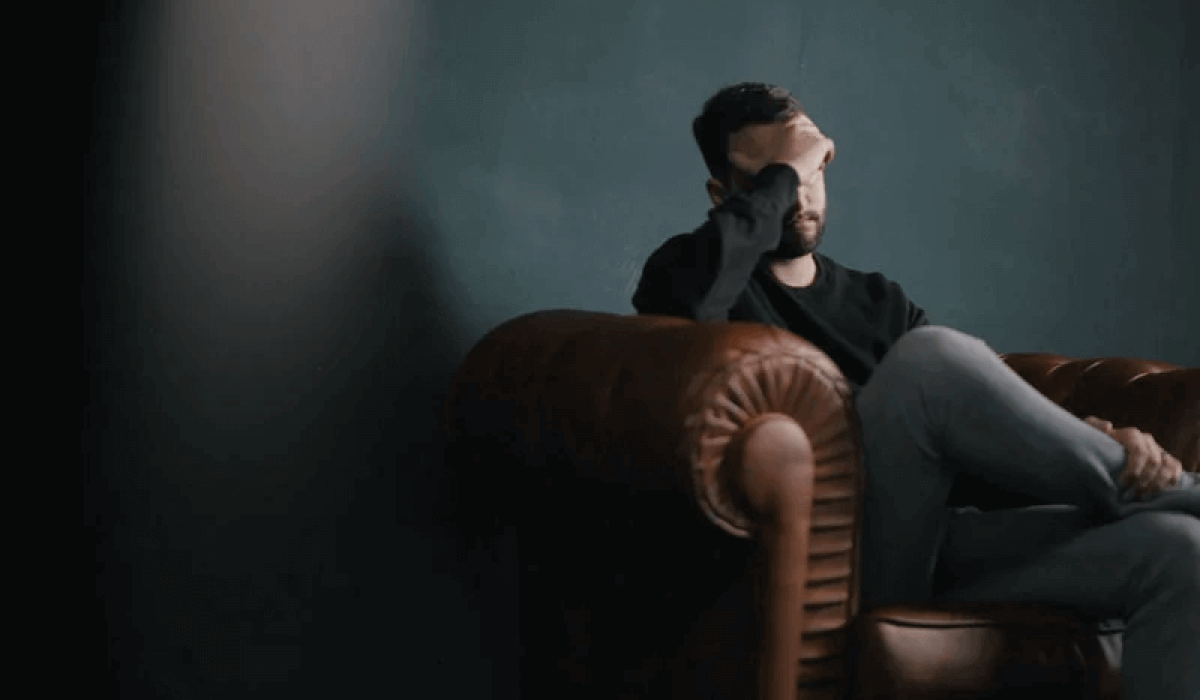 A stressed man on a couch