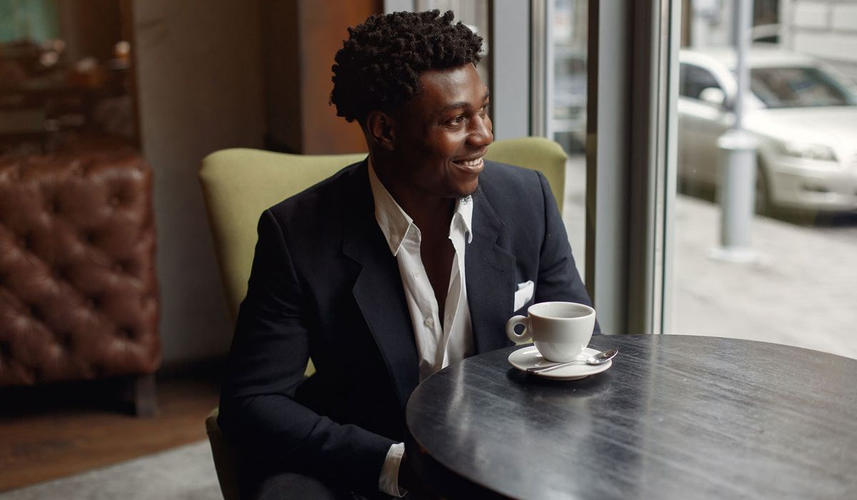 Businessmen smiling and having a coffee