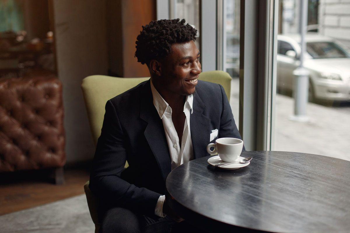 Businessmen smiling and having a coffee